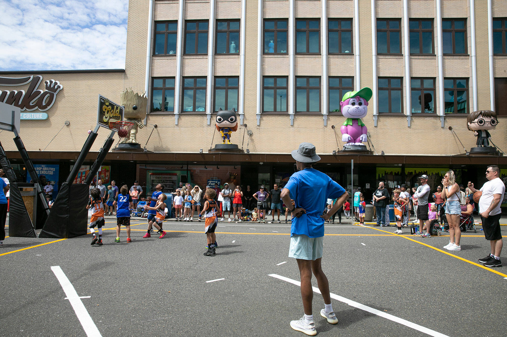 Young children play basketball in front of the Funko store Saturday during Everett 3on3 in downtown Everett. (Ryan Berry / The Herald)