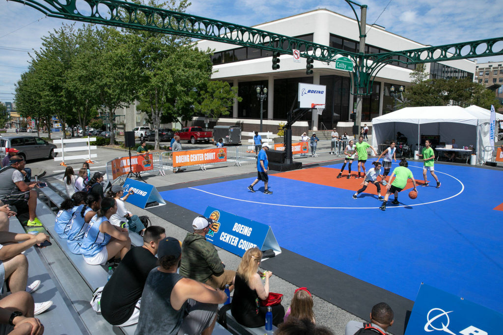 People watch a game at “Center Court” Saturday during Everett 3on3 in downtown Everett. (Ryan Berry / The Herald)
