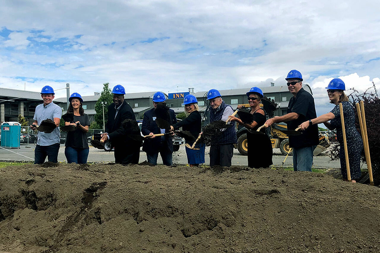 Port of Everett and City of Everett officials hoist their shovels at a ceremonial groundbreaking July 7, at Port Gardner Landing. Two new buildings will house Woods Coffee and Sound 2 Summit Brewery. (Janice Podsada / The Herald)