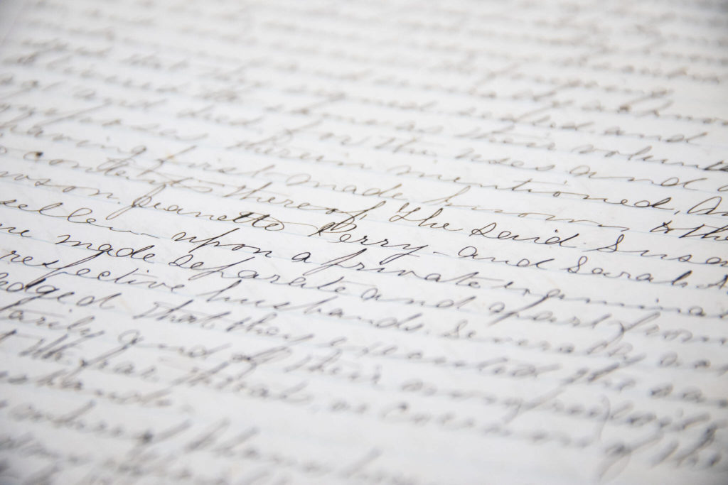 A page of cursive wiring inside Book 1 of the Snohomish County Deeds records on Tuesday, in Everett. (Olivia Vanni / The Herald)
