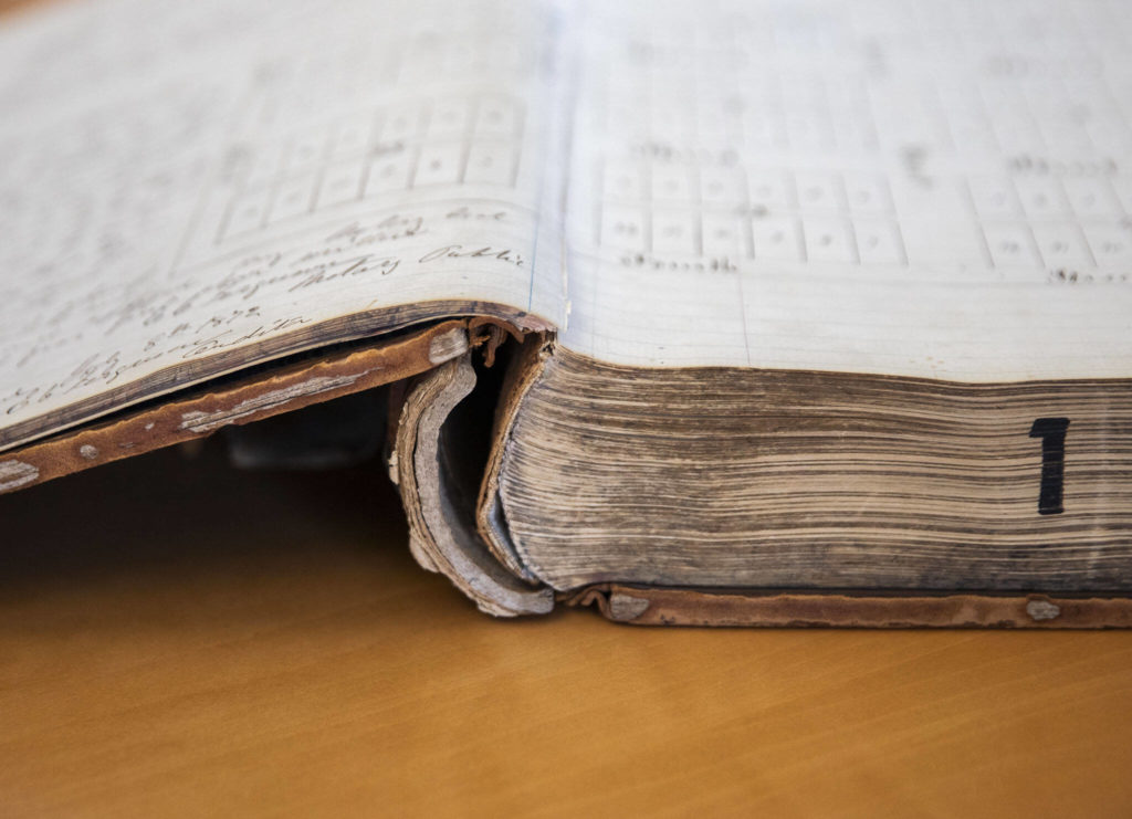 The split binding visible on Book 1 of the Snohomish County Deeds records on Tuesday, in Everett. (Olivia Vanni / The Herald)
