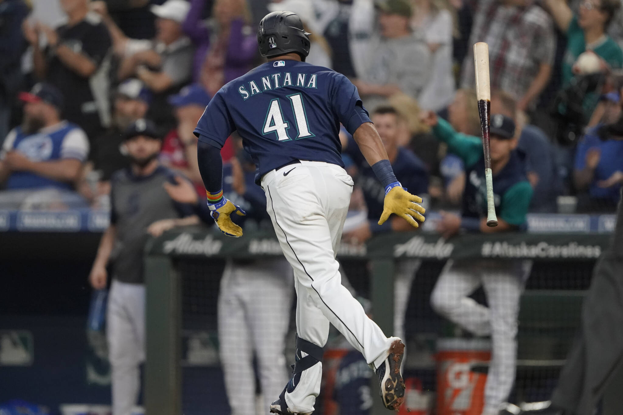 The Mariners’ Carlos Santana tosses his bat after he hit a two-run home run during the seventh inning of a game against the Blue Jays on Saturday in Seattle. (AP Photo/Ted S. Warren)