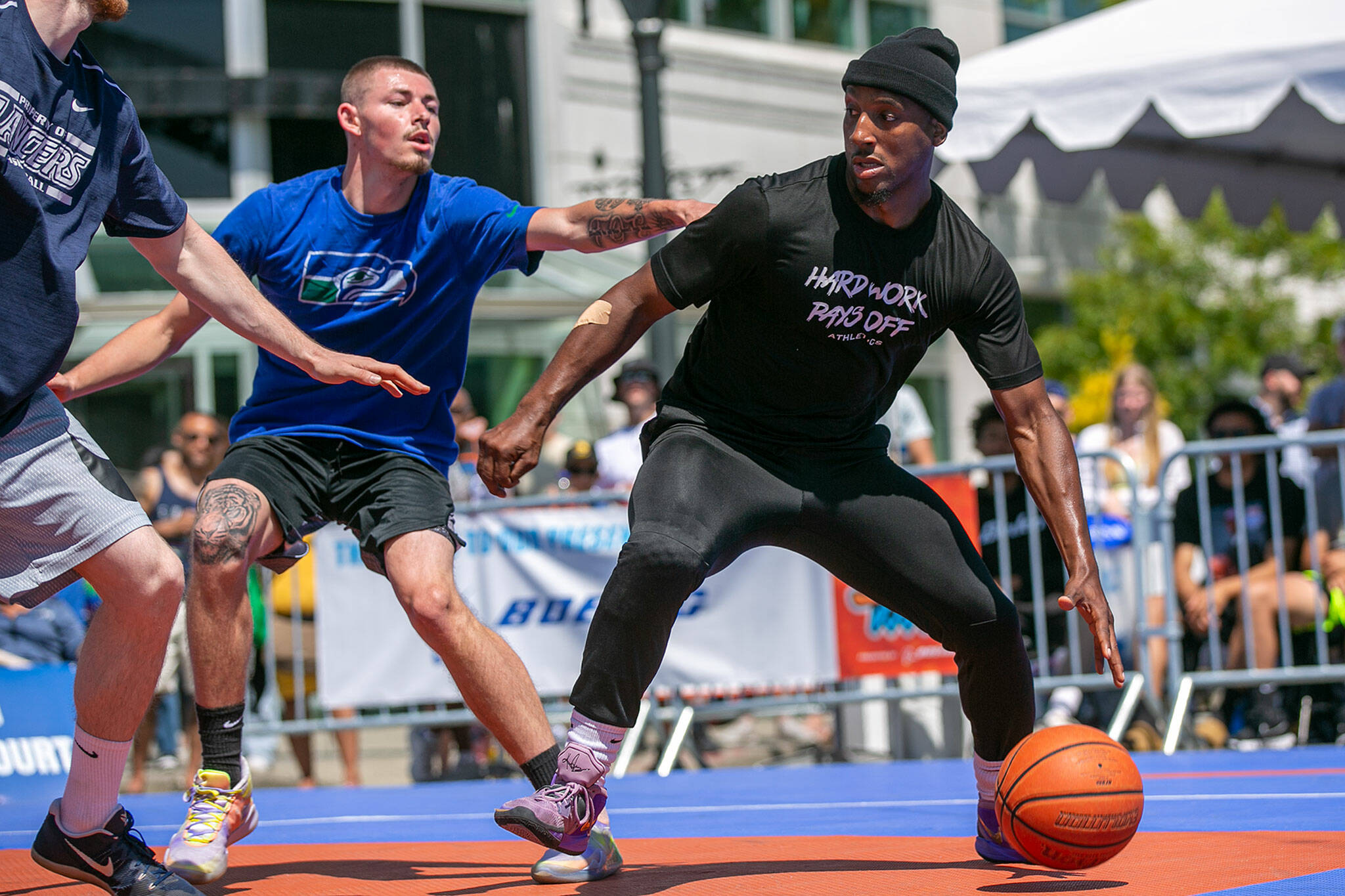Kiante Woods of MUV Elite (right) dribbles against CPC MLT’s Brevin Brown during the Men’s Elite Championship game at Everett 3on3 on Sunday in downtown Everett. (Ryan Berry / The Herald)