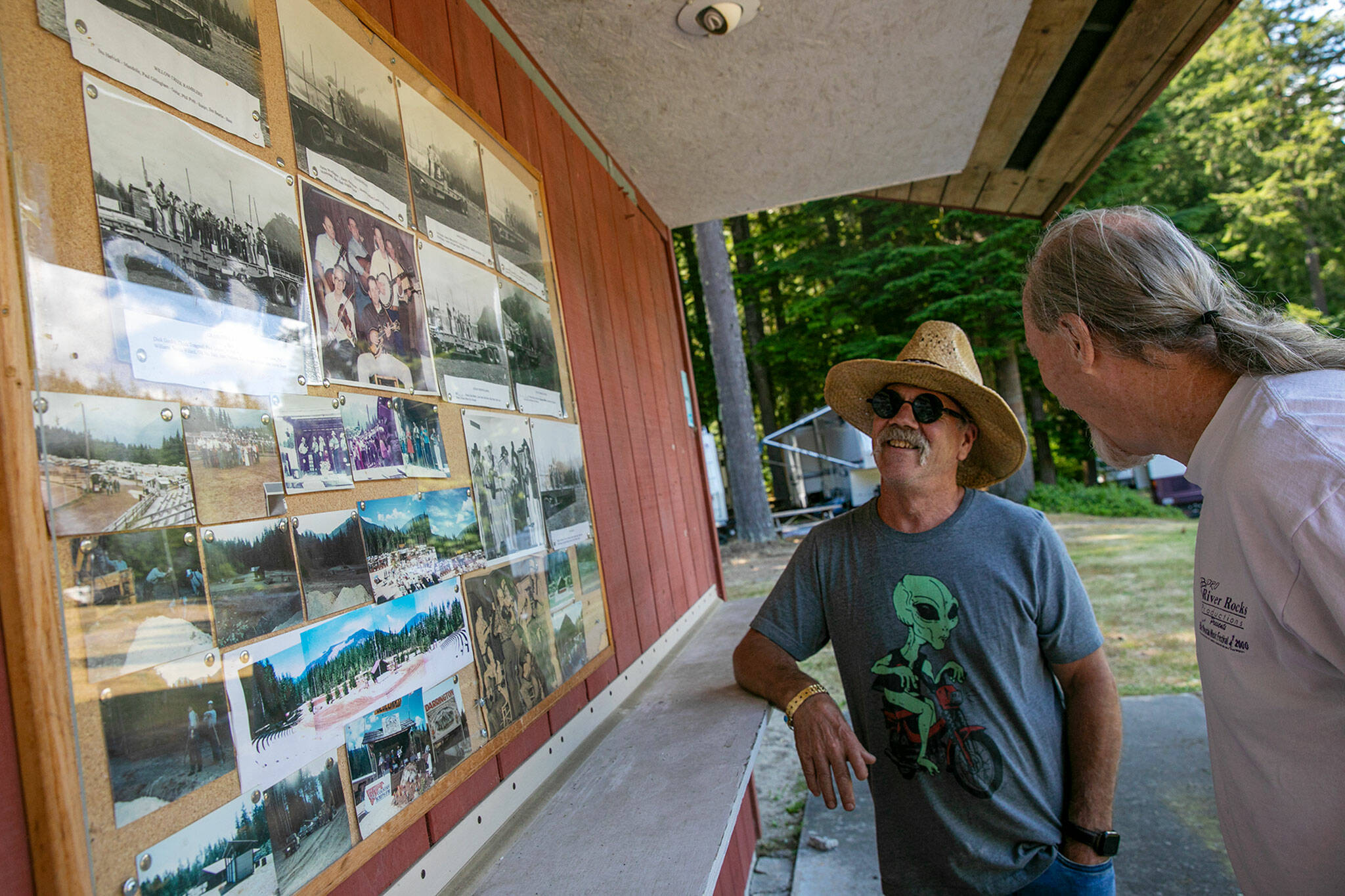 Mike Calkins and Patrick Robison talk about the history of the Darrington Bluegrass Festival on Wednesday, at Darrington Bluegrass Music Park in Darrington. (Ryan Berry / The Herald)
