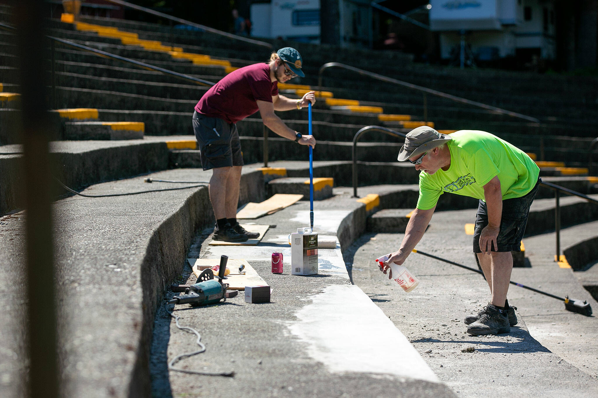 Board members Kaleb Wyatt and Larry Boyd fix up a crumbling ledge at the amphitheater on Wednesday, at Darrington Bluegrass Music Park in Darrington. The concrete at the amphitheater was poured roughly 40 years ago and remains mostly intact. (Ryan Berry / The Herald)