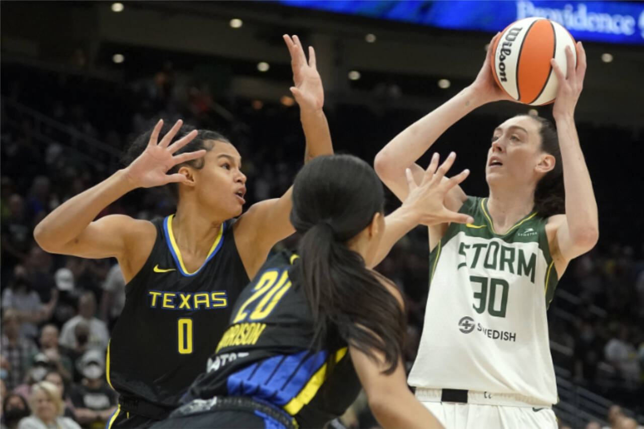 Seattle Storm forward Breanna Stewart (30) puts up a shot against Dallas Wings forward Satou Sabally (0) and guard Briann January (20) during a game Tuesday in Seattle. (AP Photo/Ted S. Warren)