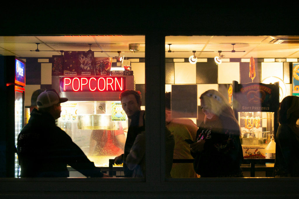 People wait in line for snacks at the Blue Fox Drive-In Theater in Oak Harbor. (Ryan Berry / The Herald)
