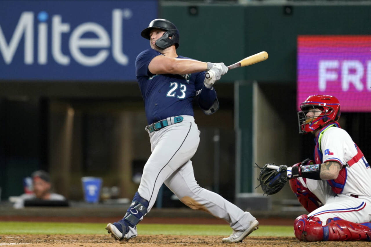 Seattle Mariners’ Ty France follows through on a two-run single against the Texas Rangers during the eighth inning Thursday’s game in Arlington, Texas. (AP Photo/Tony Gutierrez)