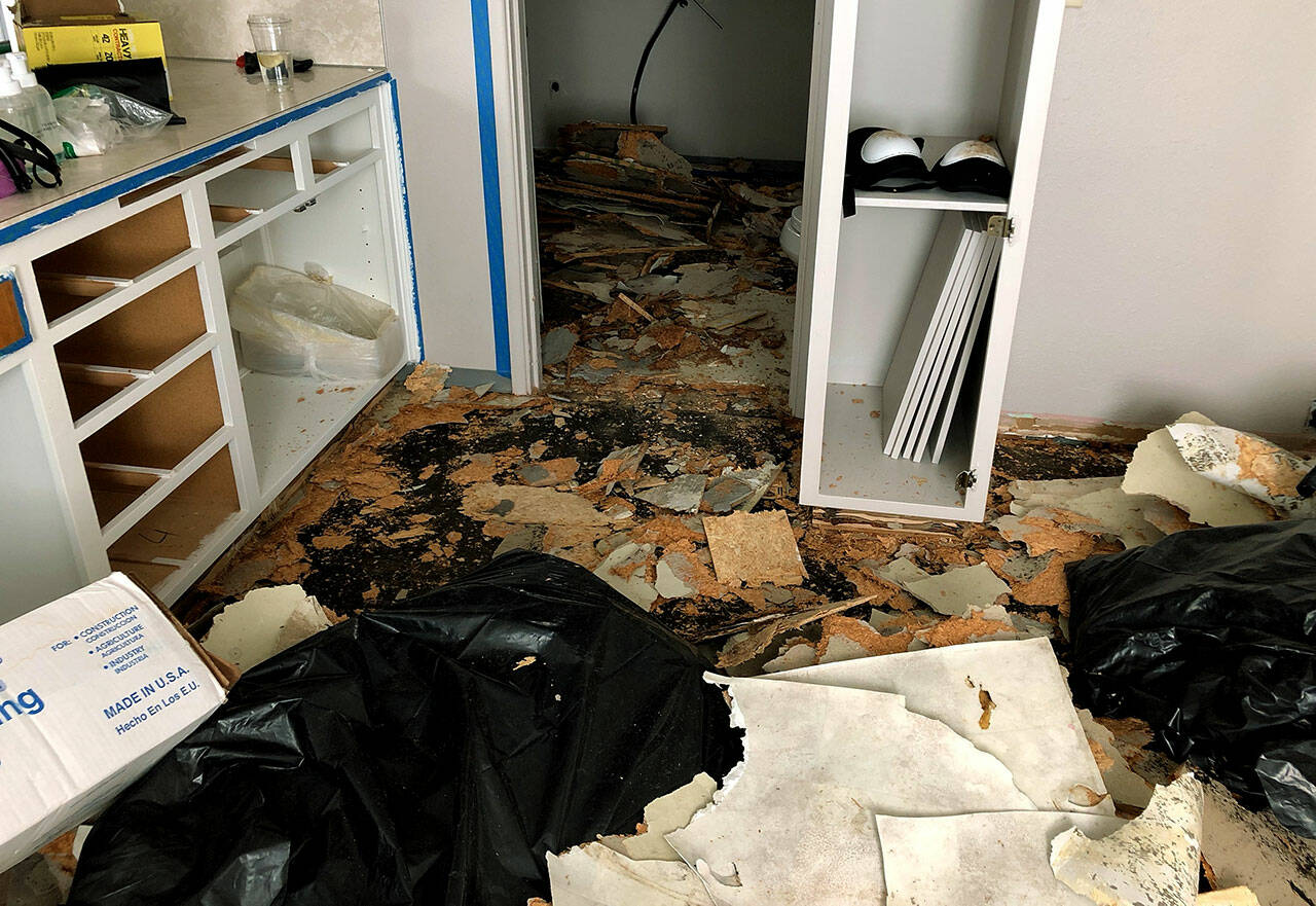 Derrick Boss, owner of Above and Beyond Asbestos Removal, left 10 gallons of asbestos material on one customer’s floor. The customer had to hire another company to complete the work. (Washington State Office of the Attorney General)