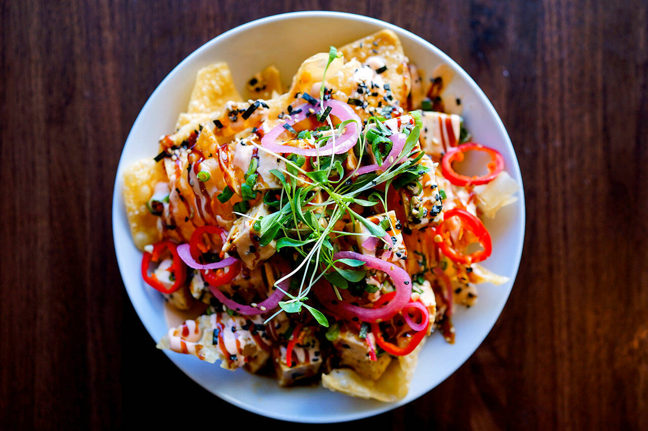 Bar Dojo’s colorful vegan nachos boast marinated organic tofu poke, Asian slaw, cilantro and vegenaise sriracha lime aioli on top of crispy wonton shells. (Photo courtesy of Bar Dojo)