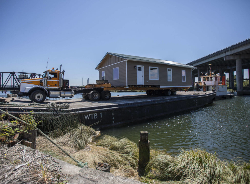 Nickel Bros successfully move Bill Liles’ home onto a barge in Ebey Slough to make its way out to Hat Island on Thursday, July 21, 2022 in Marysville, Washington. (Olivia Vanni / The Herald)
