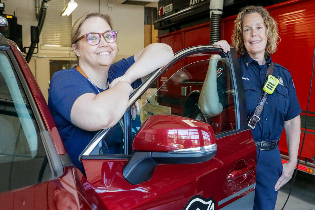 Kristena Matthews, left, a Compass Health worker and Janette Anderson a Community Resource Paramedic are part of a program aimed at providing ongoing support for people in need. Photographed in Lynnwood, Washington on July 26, 2022. (Kevin Clark / The Herald)
