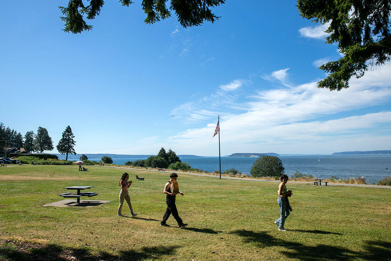 People begin to arrive at Harborview Park in the late afternoon on Thursday, July 21, 2022, in Everett, Washington. (Ryan Berry / The Herald)