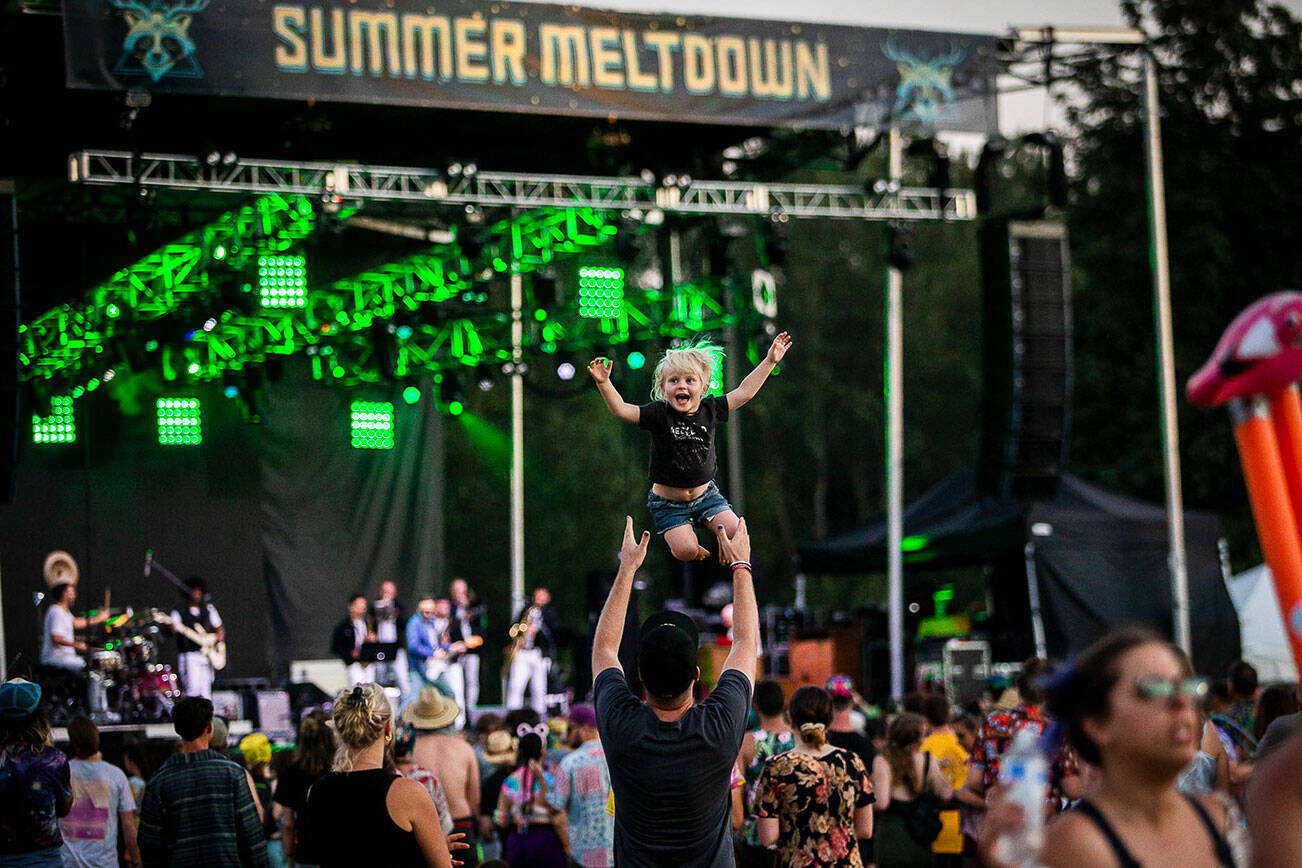 Tala Davey-Wraight, 3, is thrown in the air by her dad Oscar Davey-Wraight, one of the Summer Meltdown headliners also known as Opiuo, during Cory Wong’s set on Thursday, July 28, 2022 in Snohomish, Washington. (Olivia Vanni / The Herald)