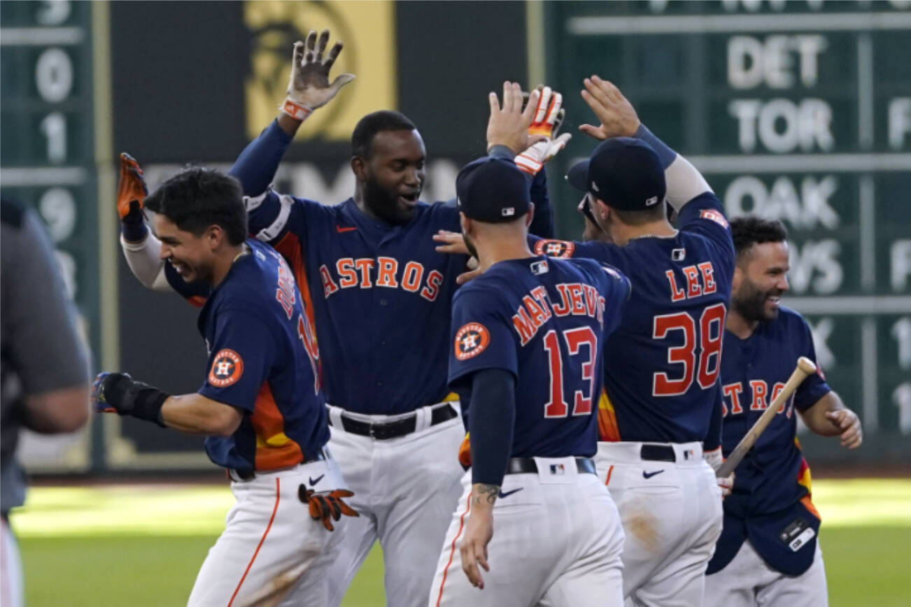 Houston Astros' Yordan Alvarez, second from left, celebrates with teammates after hitting a game-winning RBI-single against the Seattle Mariners during the 10th inning of a baseball game Sunday, July 31, 2022, in Houston. The Astros won 3-2 in 10 innings. (AP Photo/David J. Phillip)