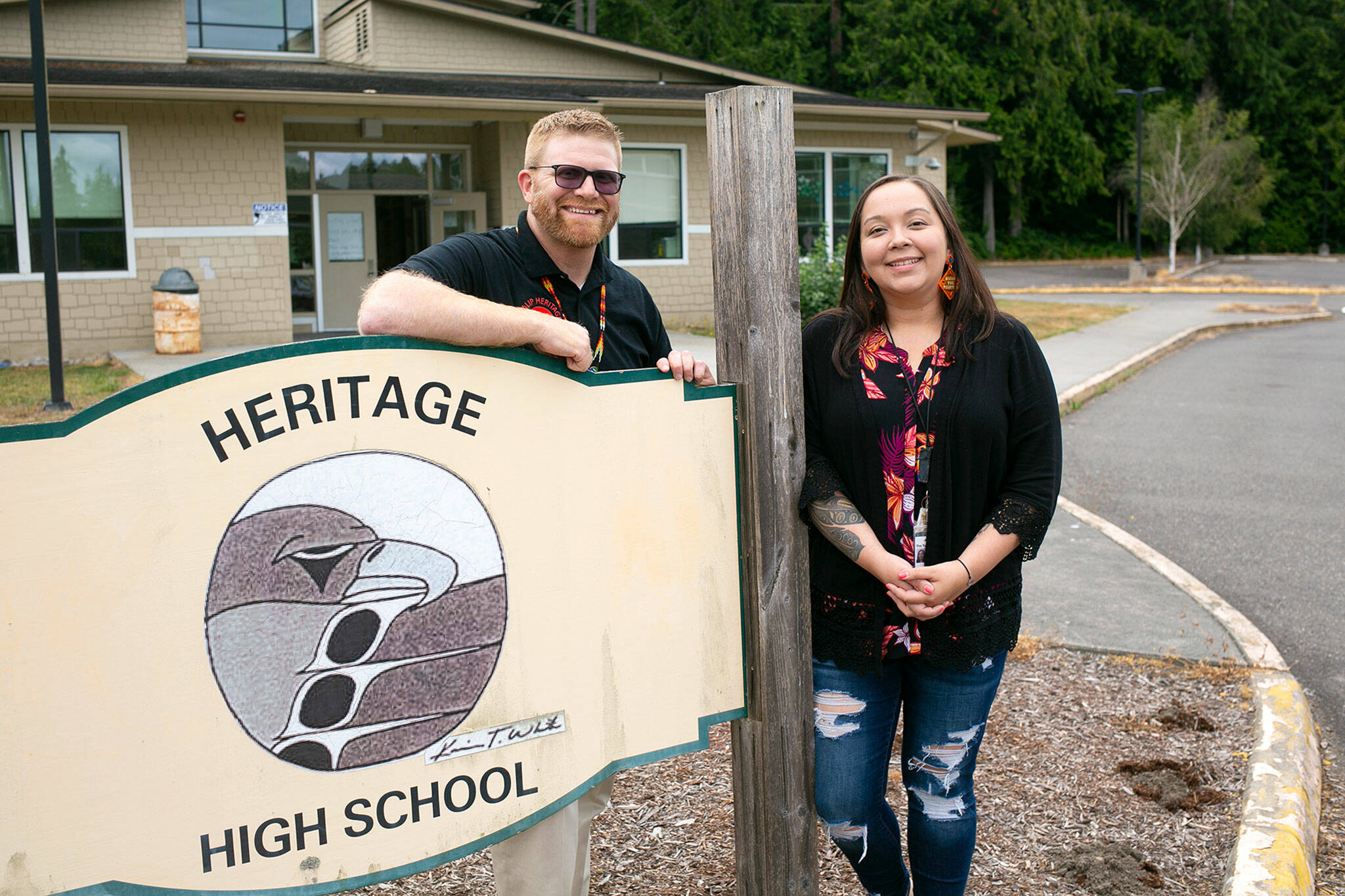 Heritage High Principal Dr. Nathan Plummer and Tulalip Education Division Executive Director Jessica Bulstad stand out front at Heritage High School on Thursday, Aug. 4, in Marysville. (Ryan Berry / The Herald)
