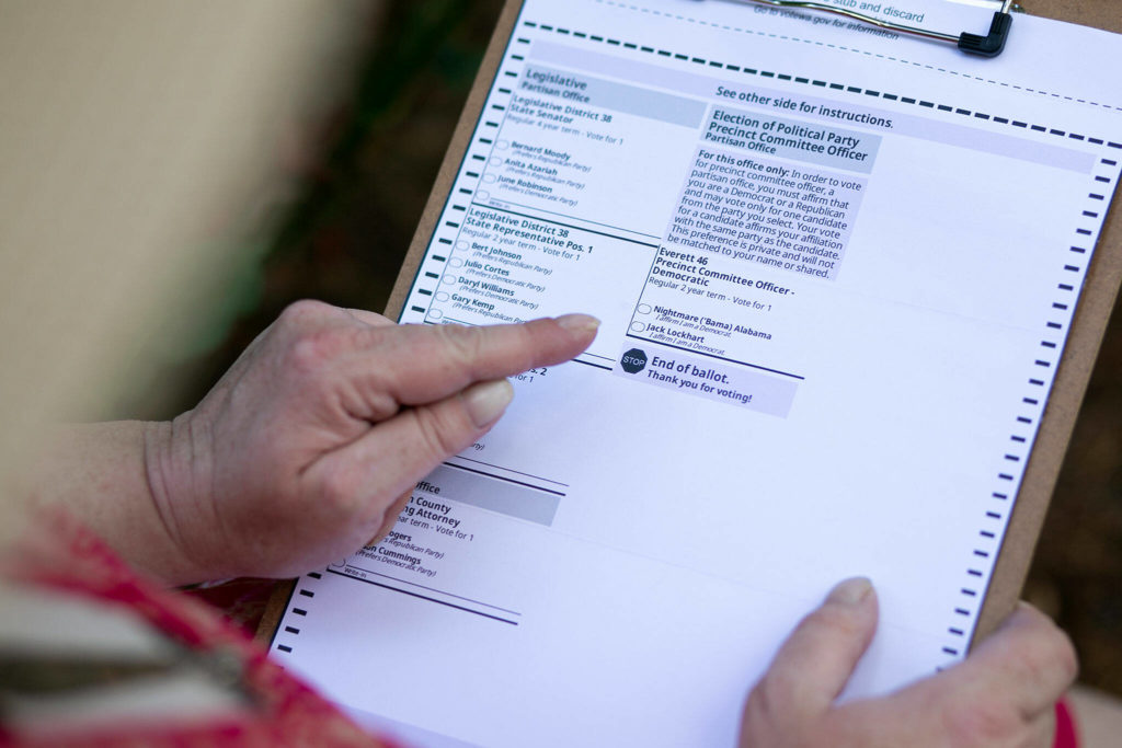 Alabama “Bama” Nightmare points out her name on her ballot with contender Jack Lockhart for Precinct 46 in Everett. (Ryan Berry / The Herald)
