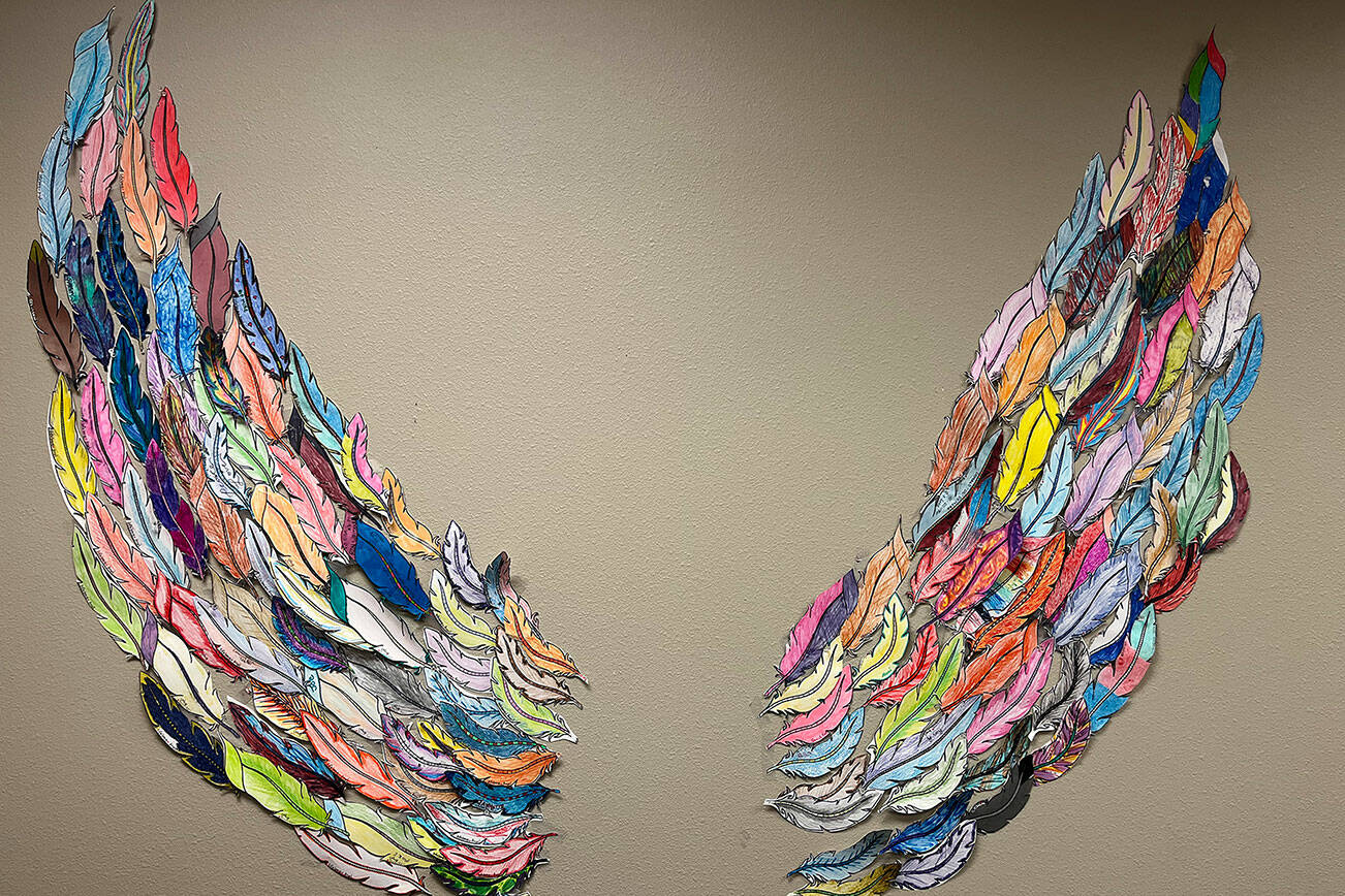 At the Lifelong office in Everett, community members created these wings to honor the victims of the AIDS epidemic. Each feather contains the name of a friend or loved one lost to the disease. (Natalie Kahn / The Herald)
