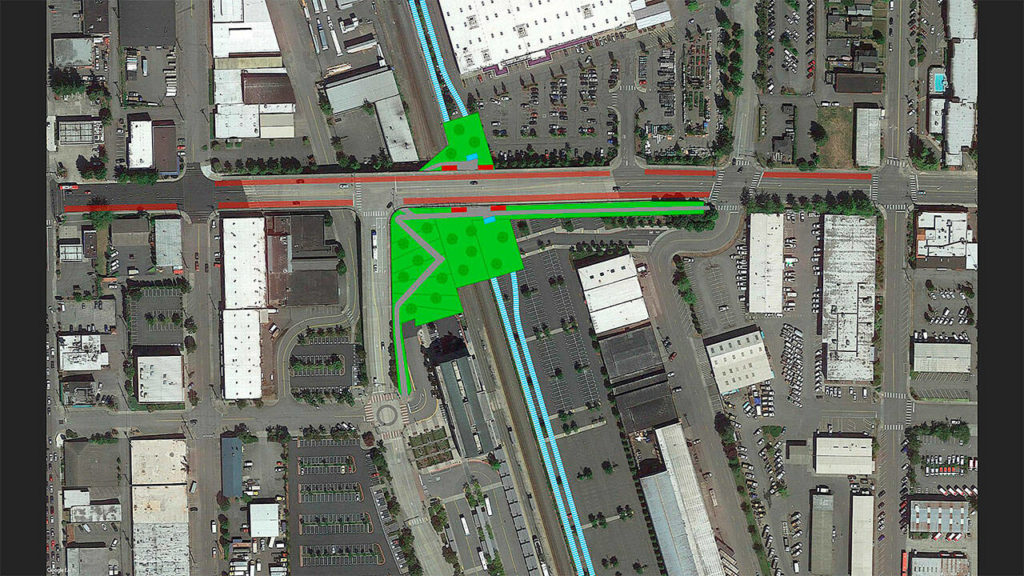 A “lid” with green space and paths to Everett Station and downtown above an elevated light rail station could help people span the existing train tracks. (Everett Station District Alliance)
