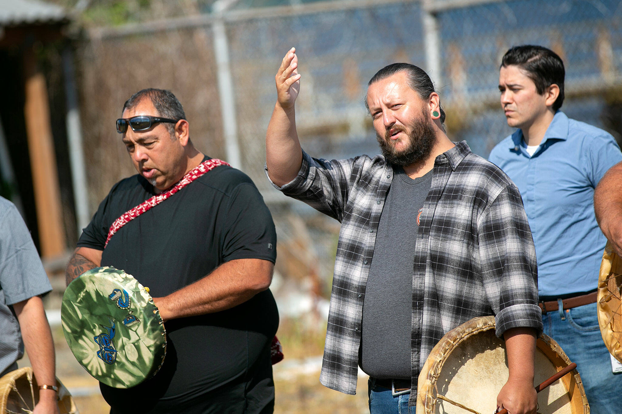 Andrew Gobin of the Tulalip Tribes greets members of NOAA before the playing of a welcoming song during a blessing ceremony Monday, at the decommissioned NOAA building on the waterfront in Mukilteo. (Ryan Berry / The Herald)