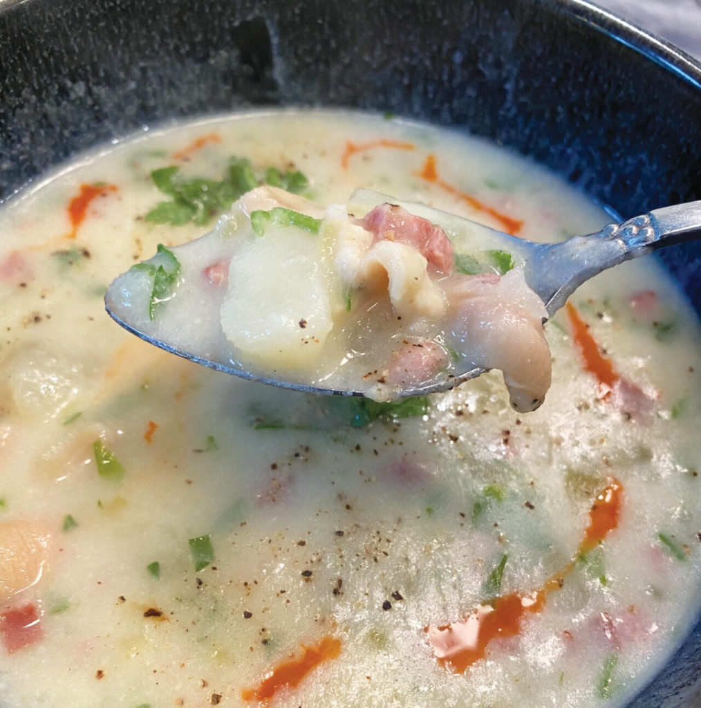 Freshly dug clams are blended into a creamy chowder of potatoes, onions, shallots, meat and spices. (Tressa Dale / Peninsula Clarion)
