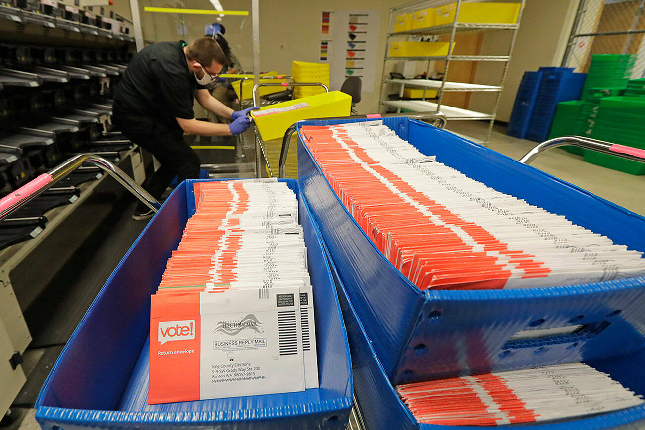 Vote-by-mail ballots are shown in sorting trays, Wednesday, Aug. 5, 2020, at the King County Elections headquarters in Renton, Wash., south of Seattle. Washington state has offered voting by mail since 2011. (AP Photo/Ted S. Warren)