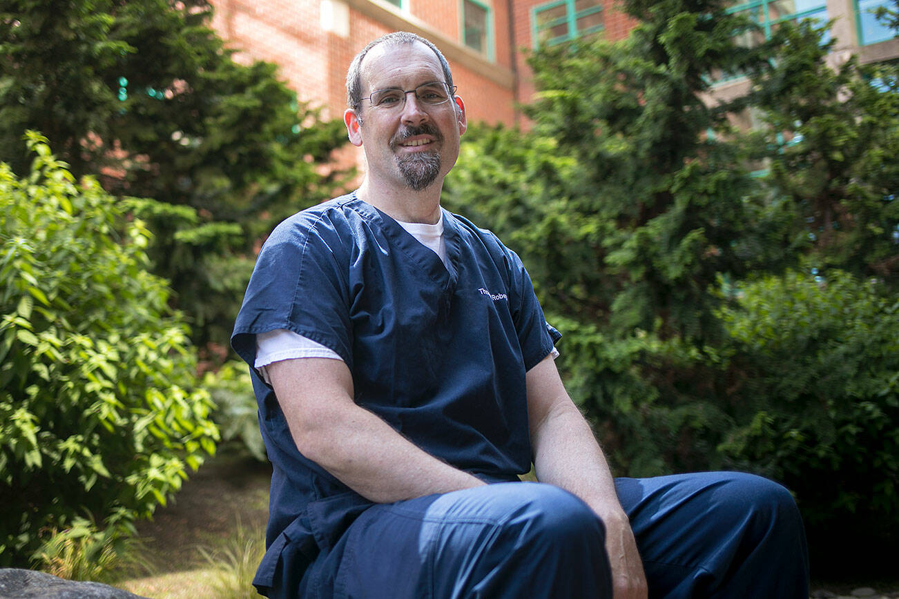 Doctor Thomas Robey sits in a courtyard at Providence Regional Medical Center on Thursday, Aug. 11, 2022, in Everett, Washington. (Ryan Berry / The Herald)