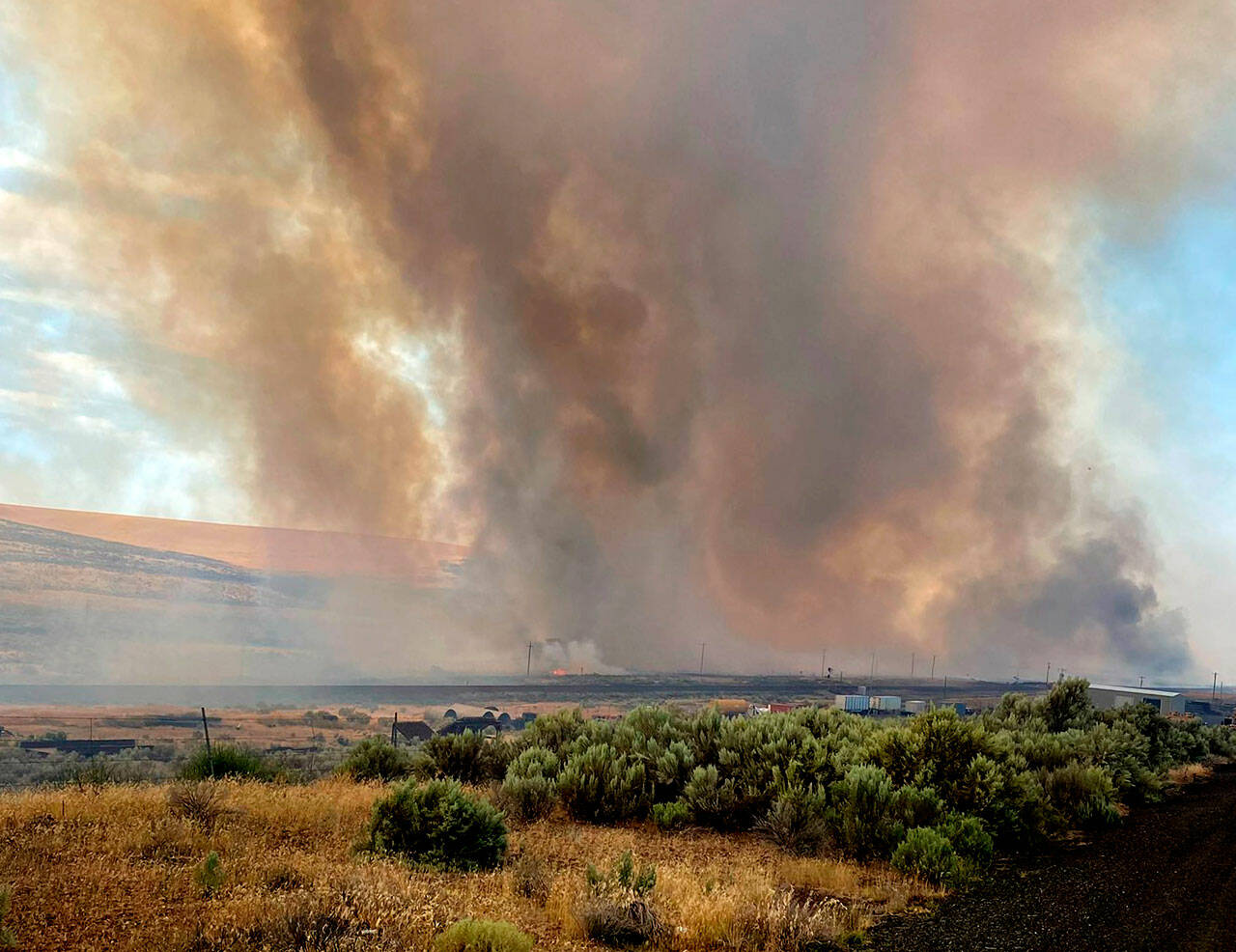 Smoke from a wildfire burns south of Lind on Thursday. (Washington State Department of Transportation via AP)