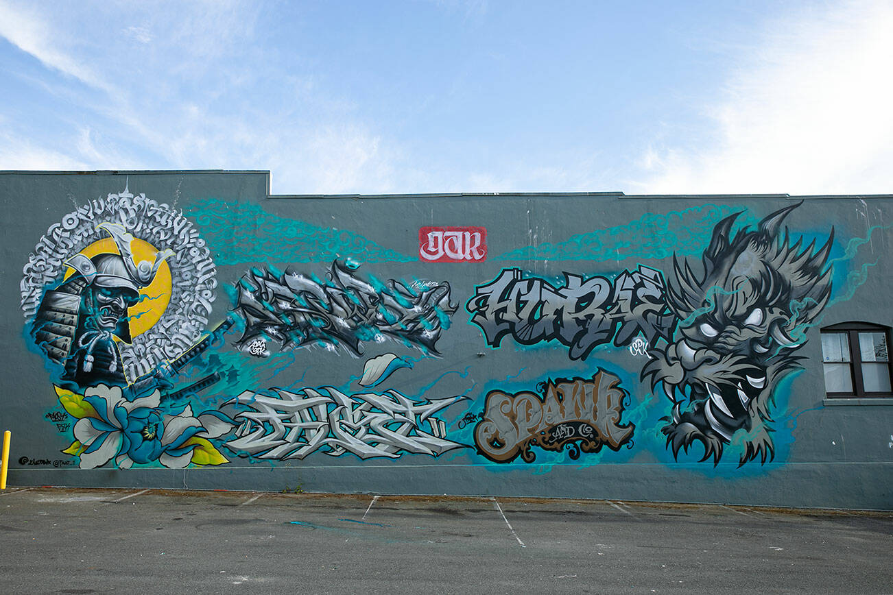 A samurai and dragon mural created during the “Going All City NW” event is seen the evening of Monday, Aug. 8, 2022, before being painted over on Tuesday along Rucker Ave. in Everett, Washington. (Ryan Berry / The Herald)