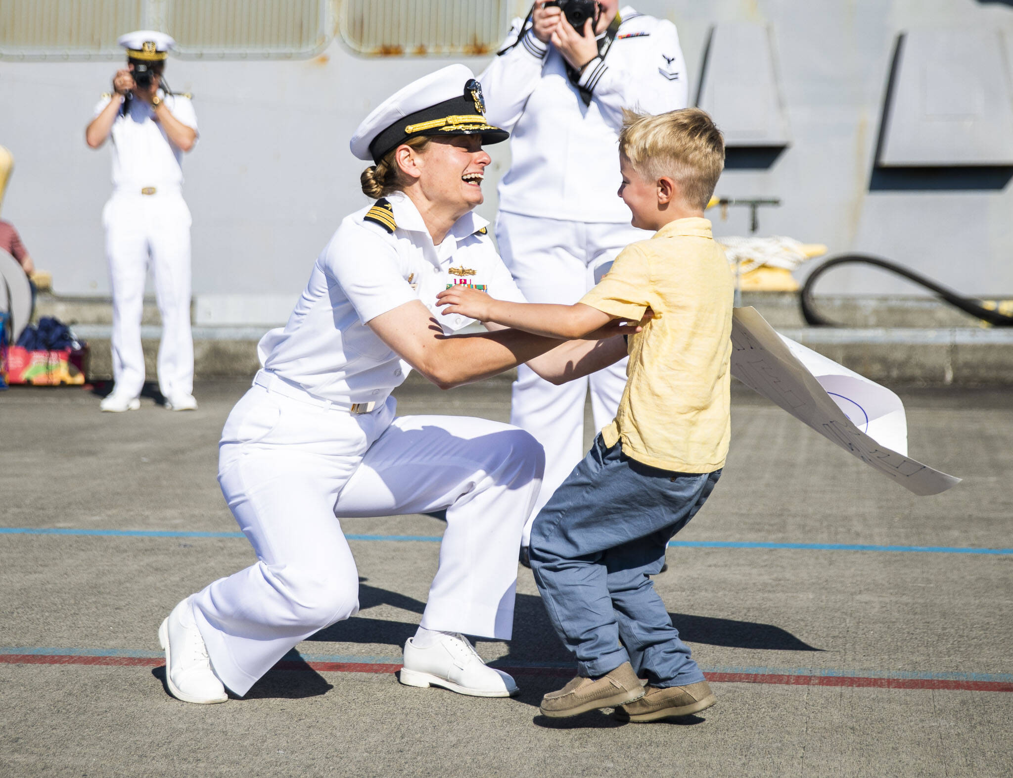 Commanding Officer Meghan Bodnar is greeted by her son Grady, who hasn’t seen her in 224 days, at Naval Station Everett on Thursday, in Everett. (Olivia Vanni / The Herald)