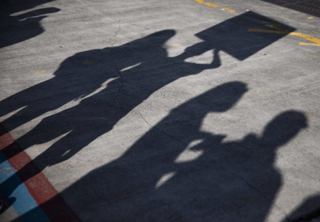 People lineup up along the dock at Naval Station Everett on Thursday, in Everett. (Olivia Vanni / The Herald) 
