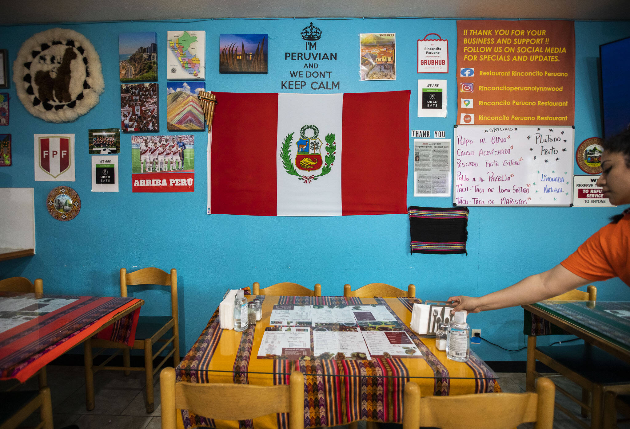 A wall covered in Peruvian photos, flags and other items at Rinconcito Peruano Restaurant on Saturday, in Lynnwood. (Olivia Vanni / The Herald)