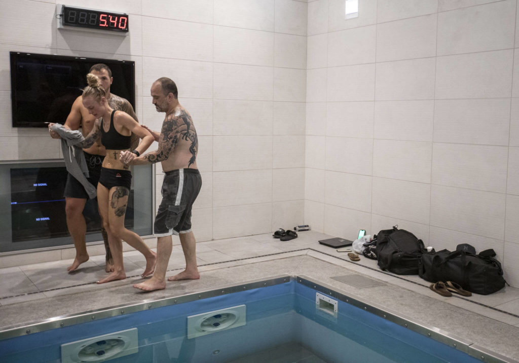 Miranda Granger is helped back into the sauna for a seven-minute session by her husband Kaden Barish and coach Charlie Pearson, during her weight cut at the UFC Performance Institute on Thursday, Aug. 4, 2022, in Las Vegas. (Olivia Vanni / The Herald)
