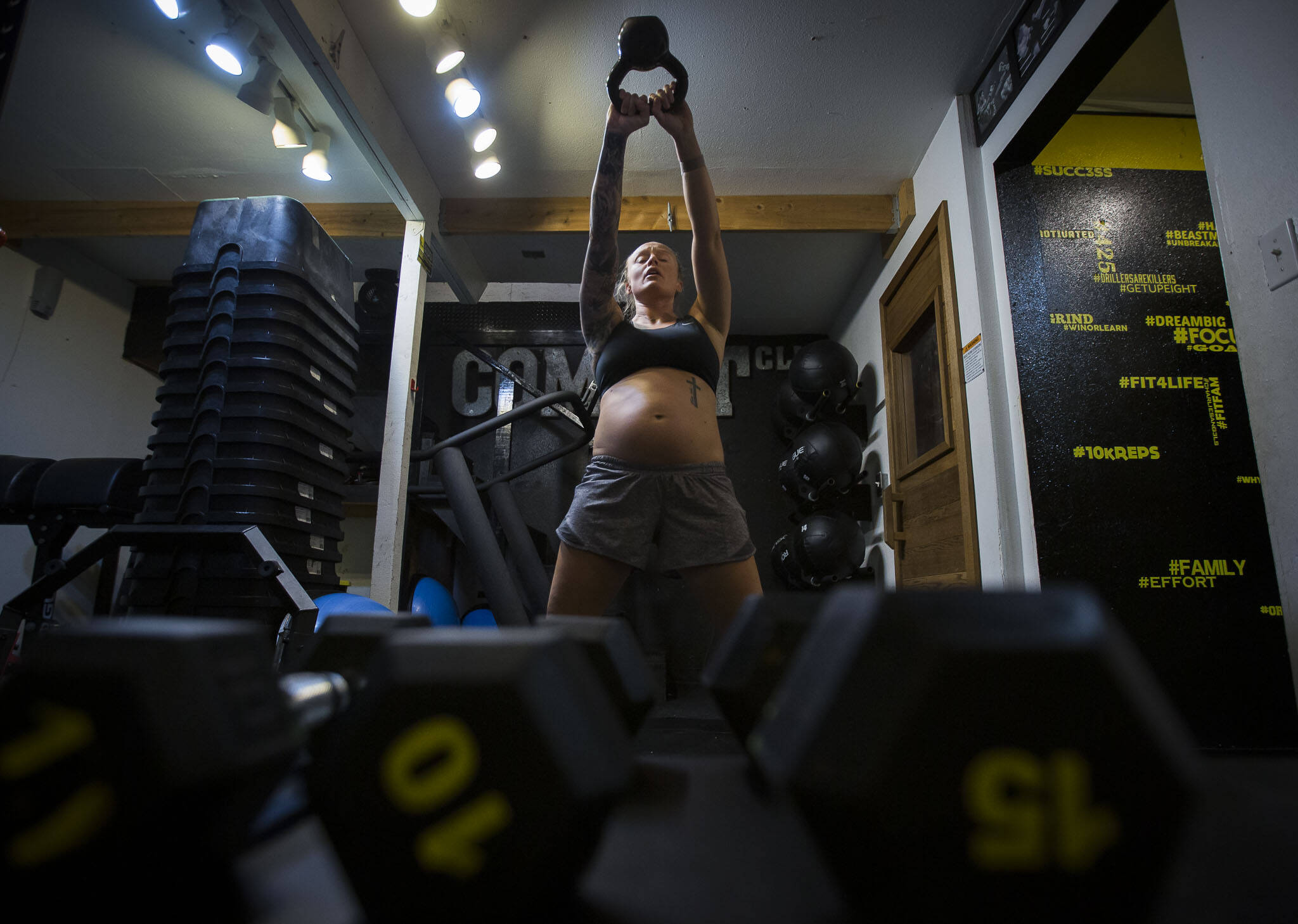 Miranda Granger works through one of the workout routines customized for her by pregnancy coach Brianna Battles at Charlie’s Combat Club on Thursday, May 13, 2022, in Everett, Washington. (Olivia Vanni / The Herald)