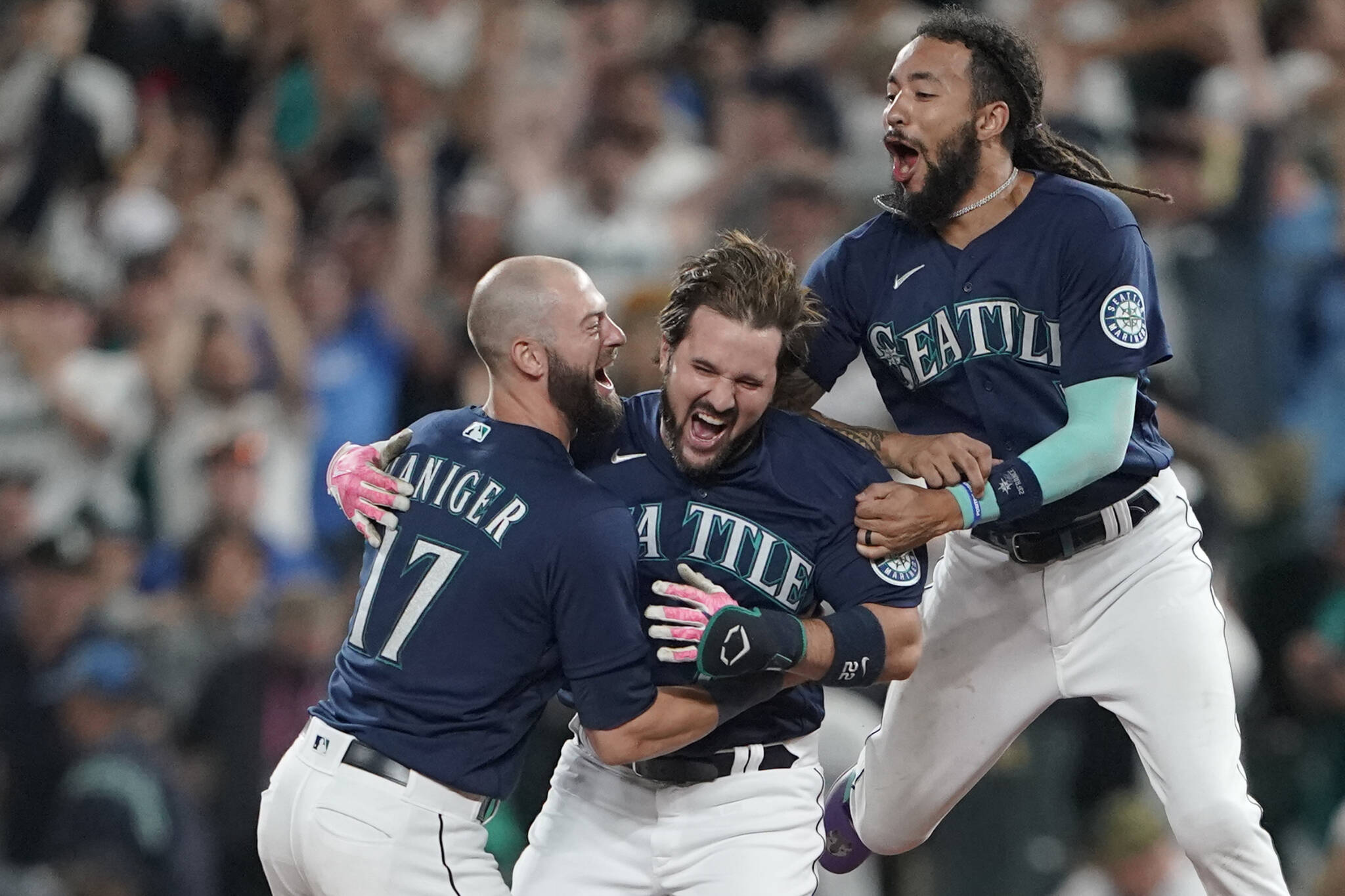 The Mariners’ Luis Torrens (center) is greeted by teammates Mitch Haniger (left) and J.P. Crawford after Torrens hit a walk-off RBI single in the 13th inning to give the Mariners a 1-0 win over the Yankees on Tuesday in Seattle. (AP Photo/Ted S. Warren)