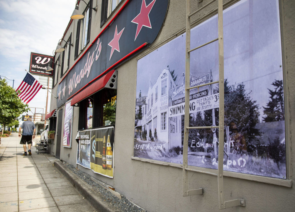 An old photograph is visible along the outside of Woody’s along Highway 99 in Shoreline. (Olivia Vanni / The Herald)
