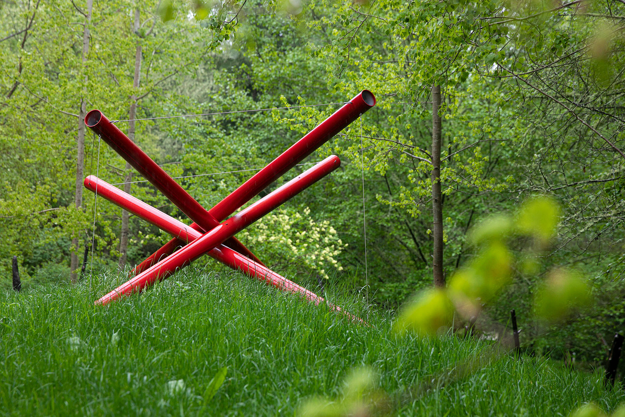 Compressed Cube Tensegrity Sculpture is one of the first sculptures seen from the east parking lot Thursday, May 5, 2022, at Earth Sanctuary in Clinton, Washington. (Ryan Berry / The Herald)