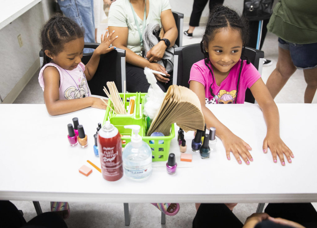 Lina and Isabella Jenkins smile after getting their nails painted during Evergreen Beauty College’s annual back-to-school beauty event on Wednesday, in Everett. (Olivia Vanni / The Herald)
