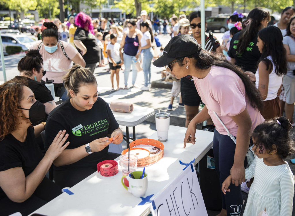 People line up for the Evergreen Beauty College’s annual back-to-school beauty event on Wednesday, in Everett. (Olivia Vanni / The Herald)
