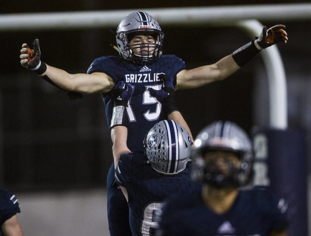 Glacier Peak’s Trey Leckner is hoisted in the air by his teammate in celebration of his touchdown during a game against Bothell on Nov. 12, 2021 in Snohomish. (Olivia Vanni / The Herald)
