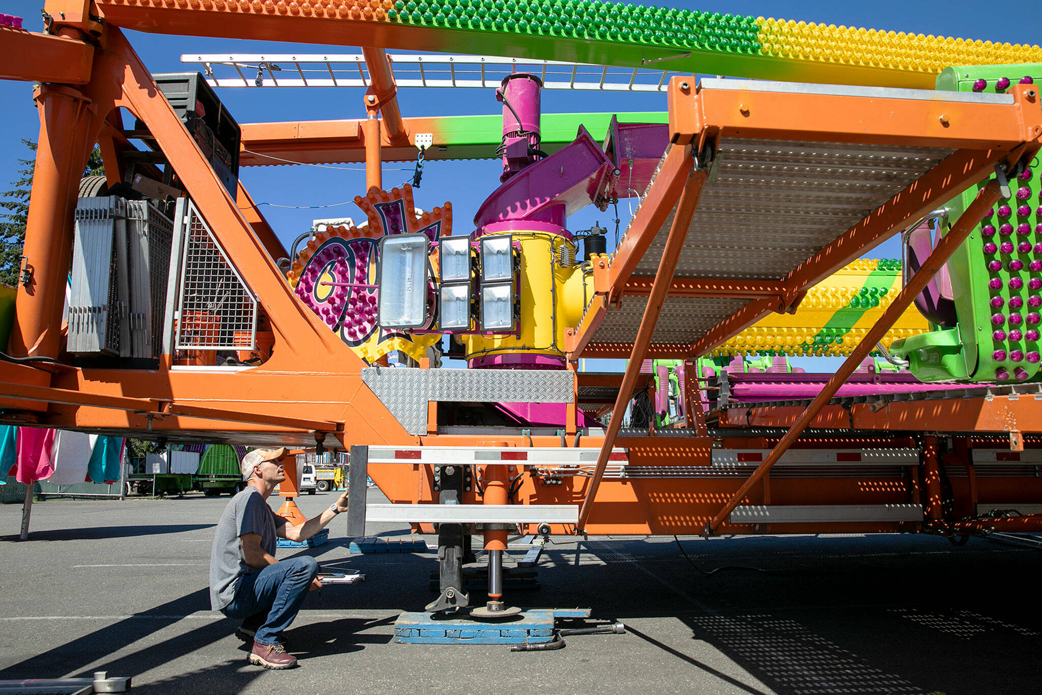 Dustin Allen, an Indiana-based service technician for Semcor Manufacturing, inspects the Freak Out as the state fair approaches on Monday, at the Evergreen State Fairgrounds in Monroe. (Ryan Berry / The Herald)