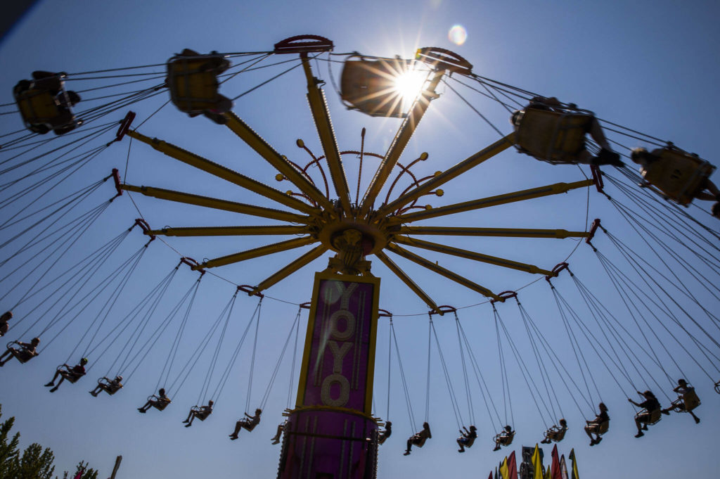 People enjoy the Yoyo ride during opening day of the Evergreen State Fair on Thursday, in Monroe. (Olivia Vanni / The Herald)
