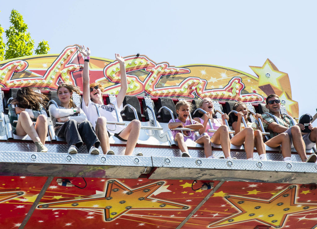 People scream and yell while on a ride during opening day of the Evergreen State Fair on Thursday, in Monroe. (Olivia Vanni / The Herald)
