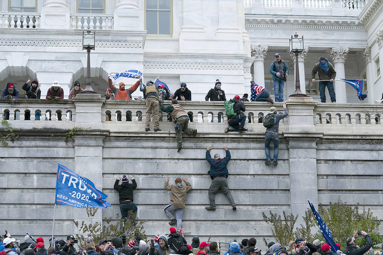 Violent insurrectionists loyal to President Trump scale the west wall of the the U.S. Capitol in Washington, D.C., on Jan. 6, 2021. Proposed reforms to the Electoral Count Act could limit the possibility of a repeat of that day’s events. (Jose Luis Magana / Associated Press file)