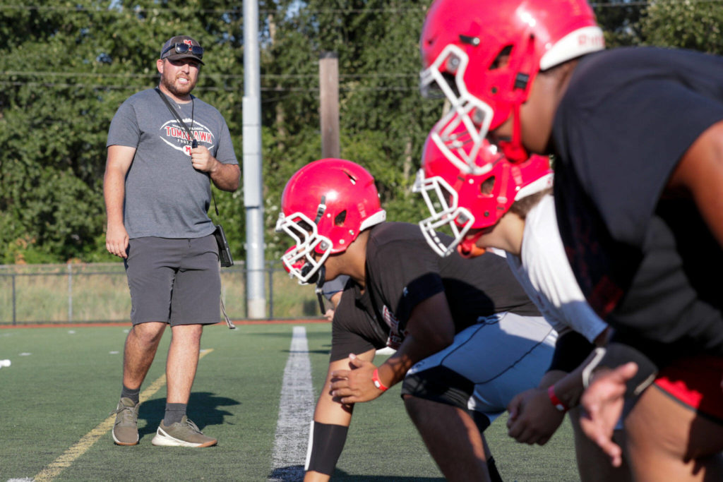 Marysville Pilchuck head coach Dalton Schwetz watches the offensive line during practice Wednesday afternoon at Marysville Pilchuck High School. (Kevin Clark / The Herald)
