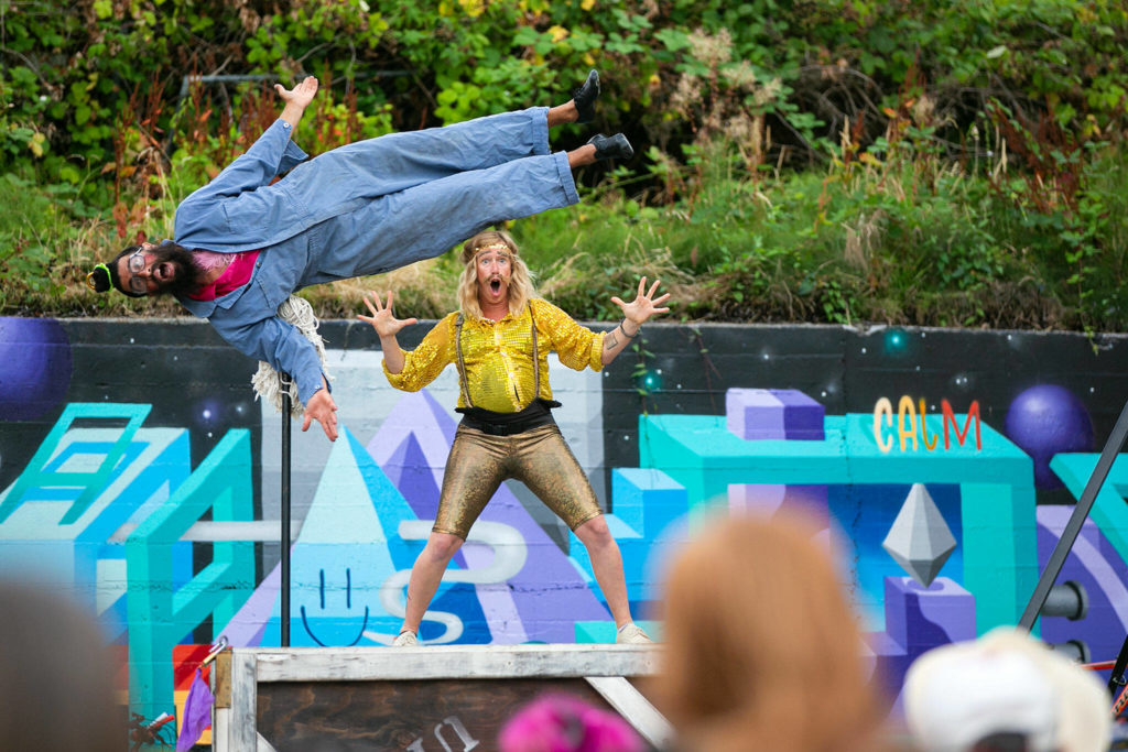 Performers show off their mop talents during Up Up Up Crane Circus’ evening performance Friday, in the empty lot at Hewitt and Oakes in downtown Everett. (Ryan Berry / The Herald)
