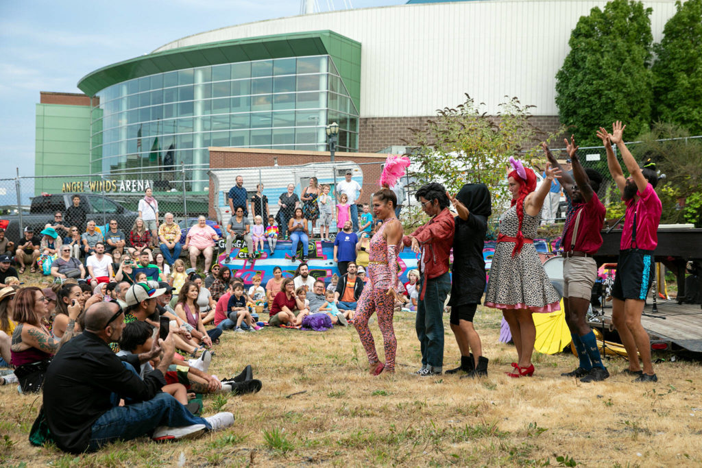 The Up Up Up performers introduce themselves during their evening circus performance Friday, in the empty lot at Hewitt and Oakes in downtown Everett. (Ryan Berry / The Herald)
