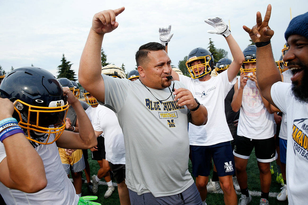 First year Mariner football head coach Tyler Tuiasosopo gathers his team for a talk between drills during practice Thursday, Aug. 18, 2022, at Mariner High School in Everett, Washington. (Ryan Berry / The Herald)