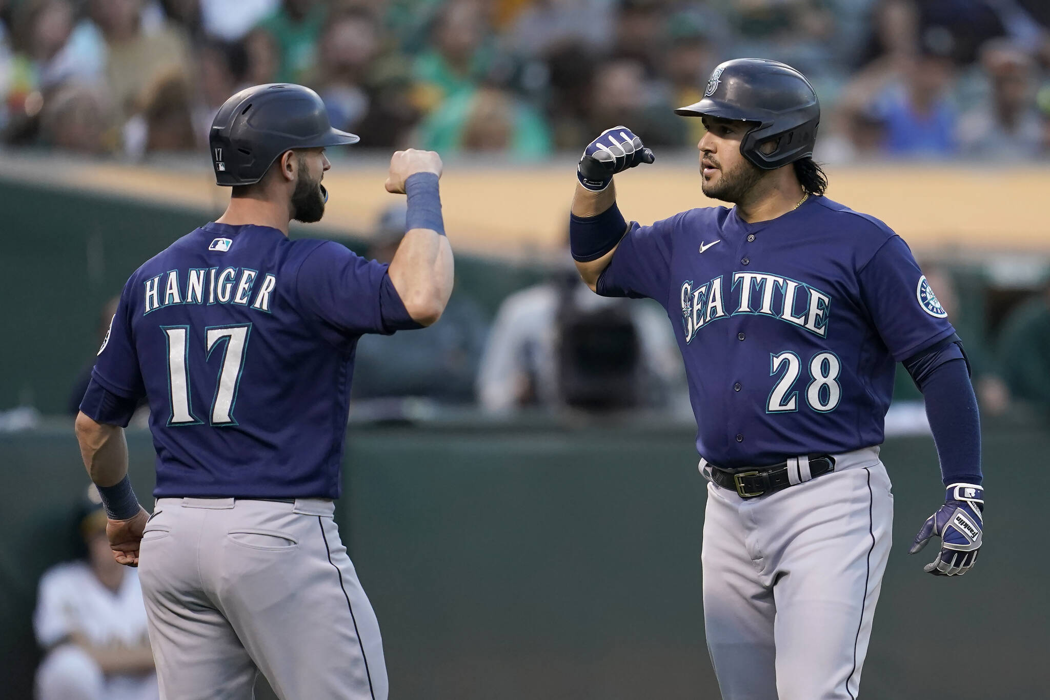 The Mariners’ Eugenio Suarez (28) celebrates after hitting a two-run home run that scored Mitch Haniger (17) during the fourth inning of a game against the Athletics on Friday in Oakland, Calif. (AP Photo/Jeff Chiu)