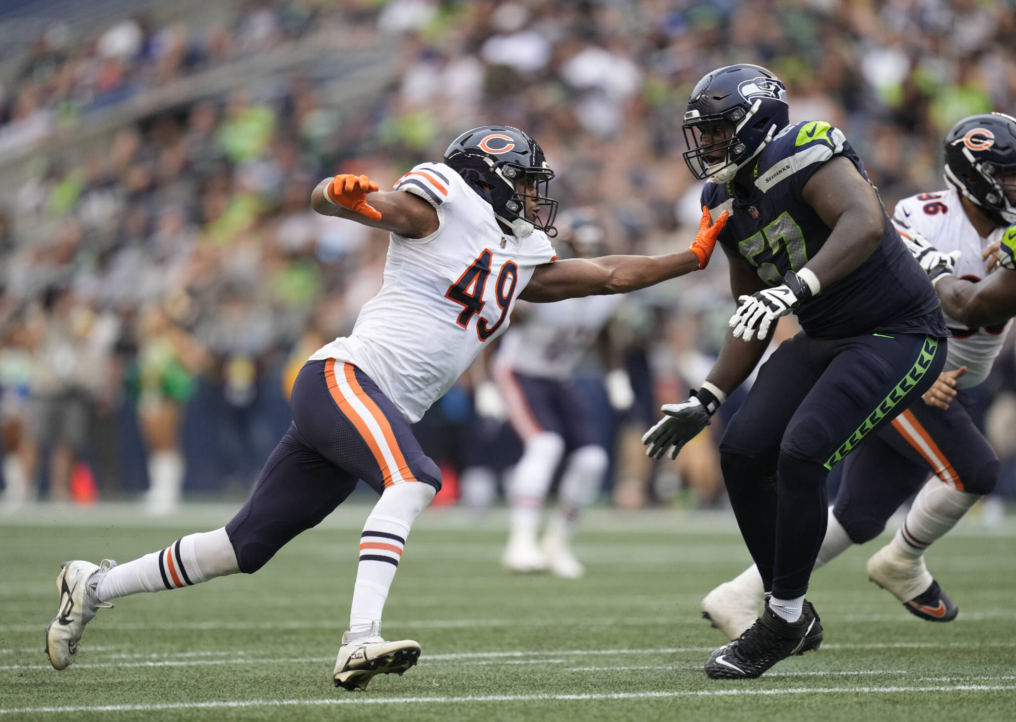 Seahawks offensive tackle Charles Cross (67) blocks Bears linebacker Charles Snowden (49) during a preseason game on Aug. 18 in Seattle. (AP Photo/Ben VanHouten)